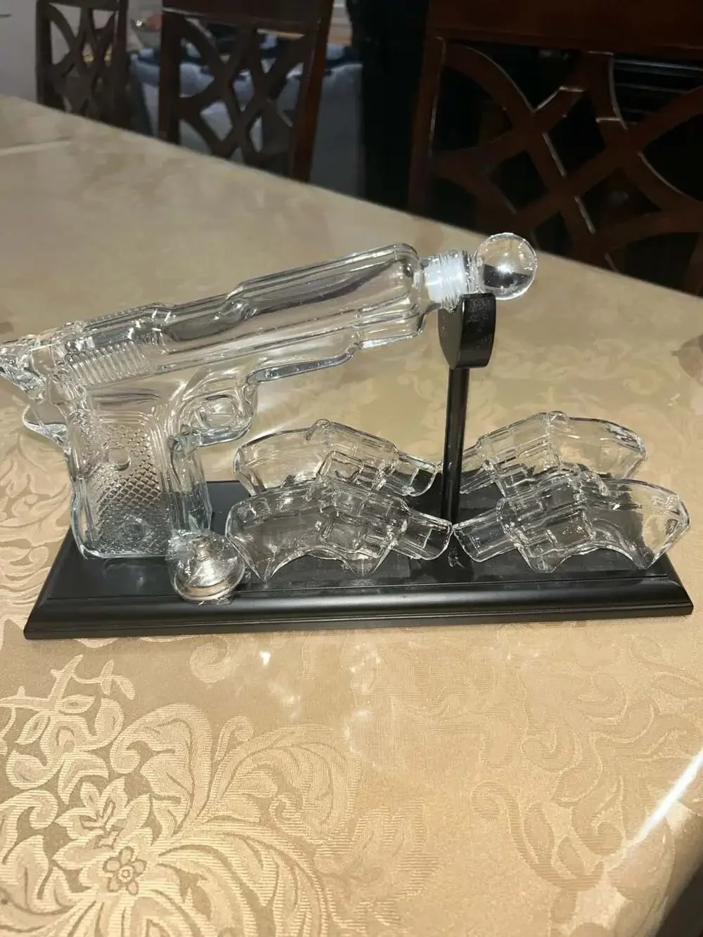 Clear Glass Pistol Decanter Set with Four Glass Shot Glasses on Display Stand